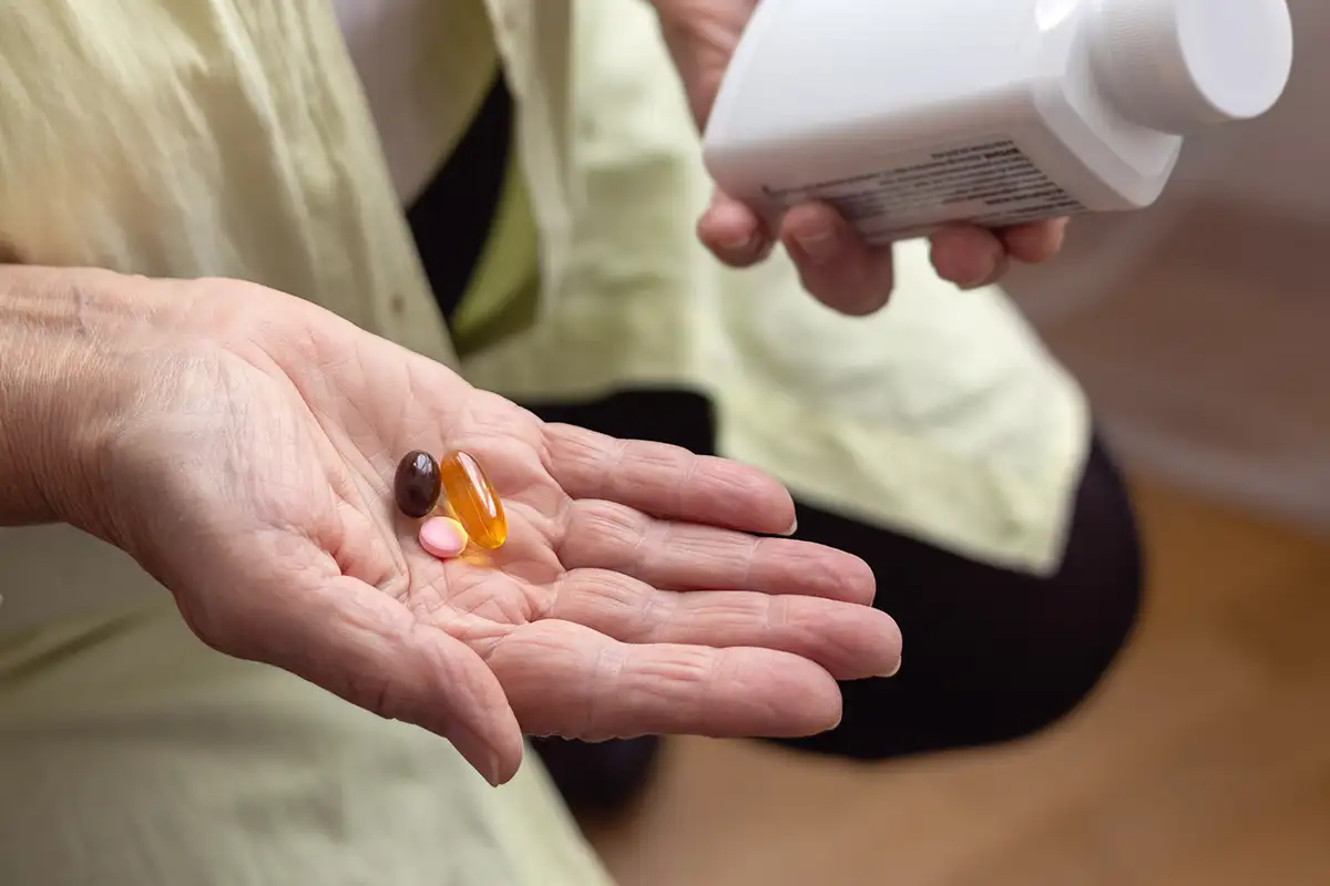 Senior taking vitamin supplements