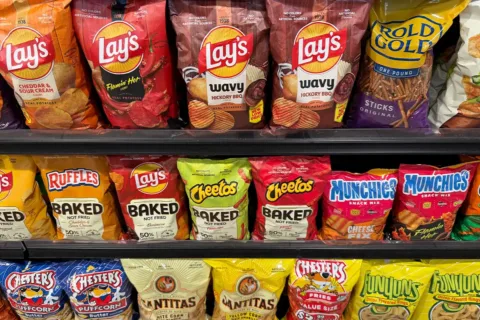 potato chips and other snacks on a store shelf