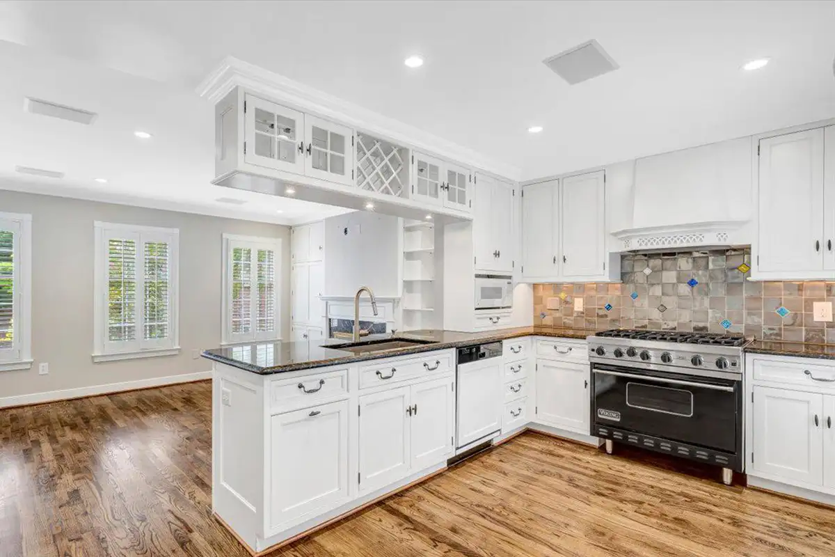 Kitchen with stone backsplash and custom cabinetry