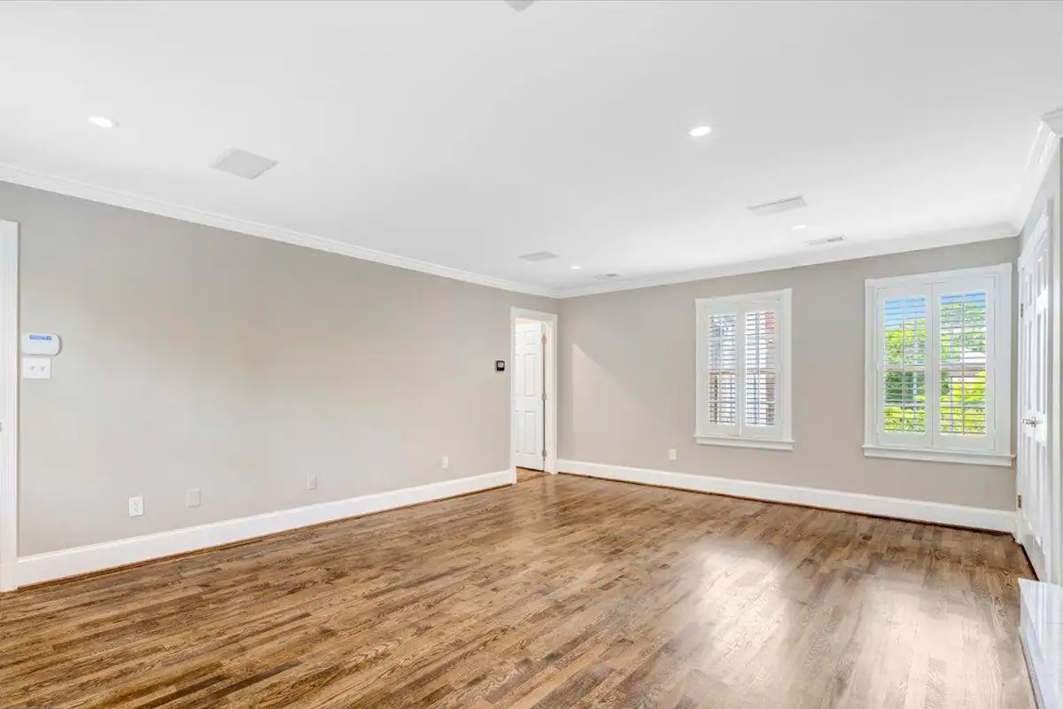 Primary bathroom with large windows and wood floors