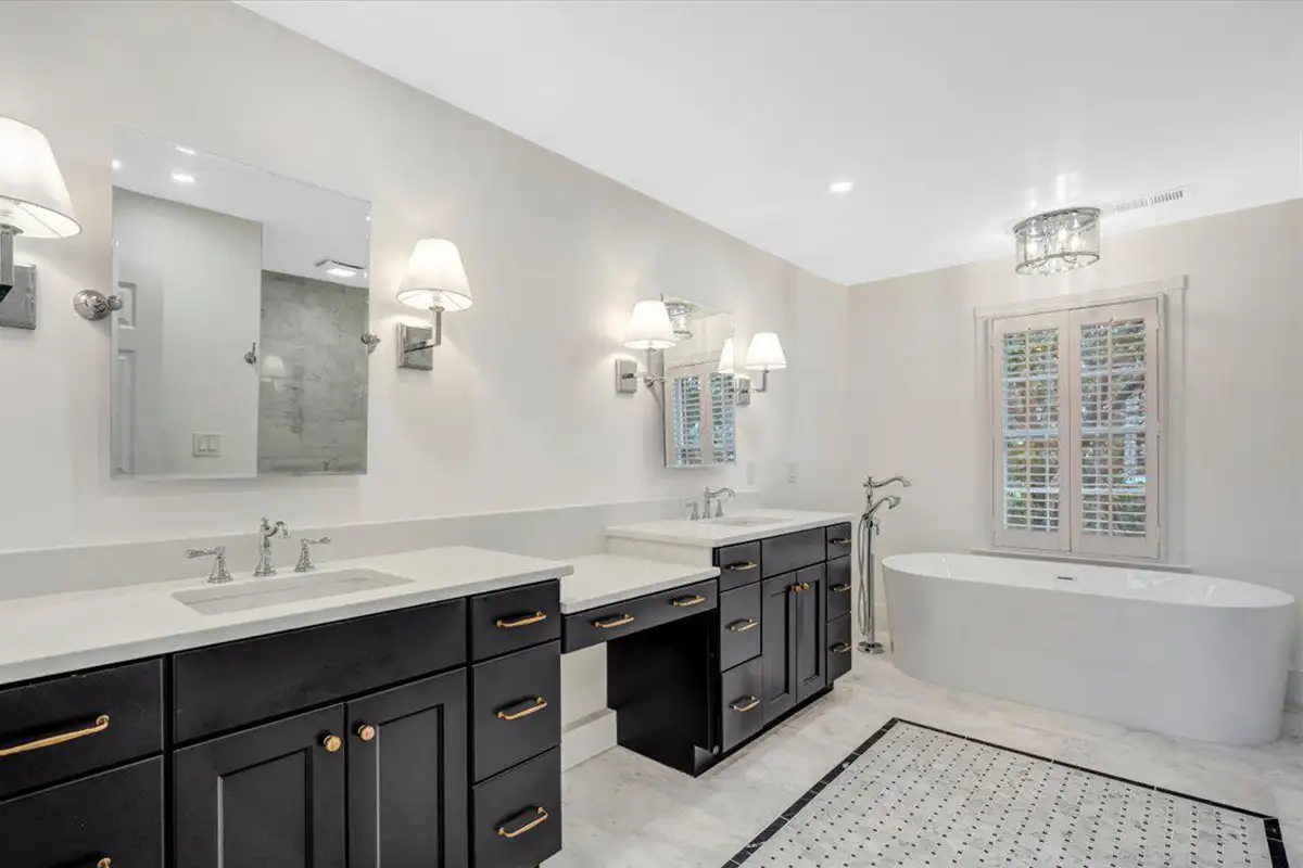 Primary bathroom with double vanity and large bathtub