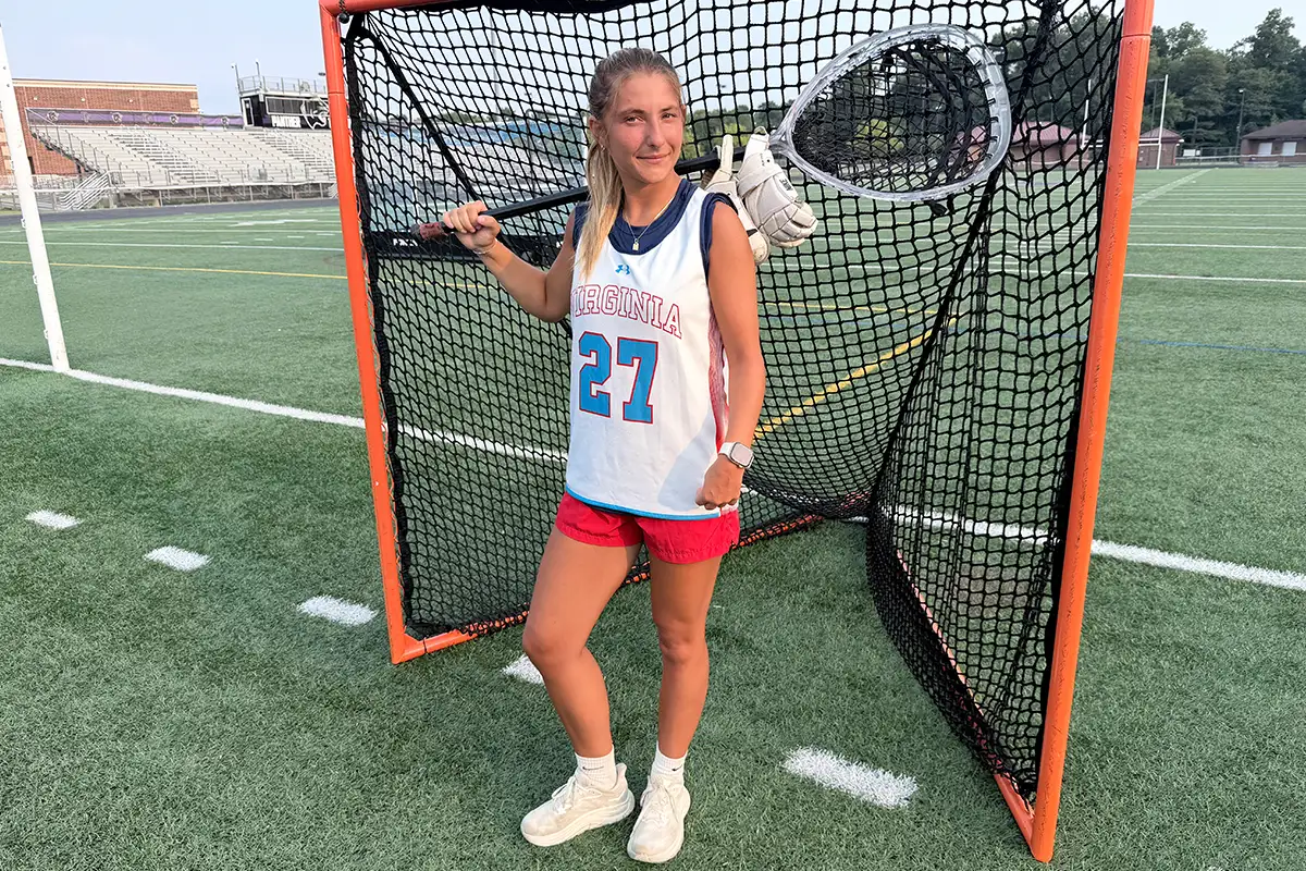 Reagan Bischoff stands in a lacrosse goal