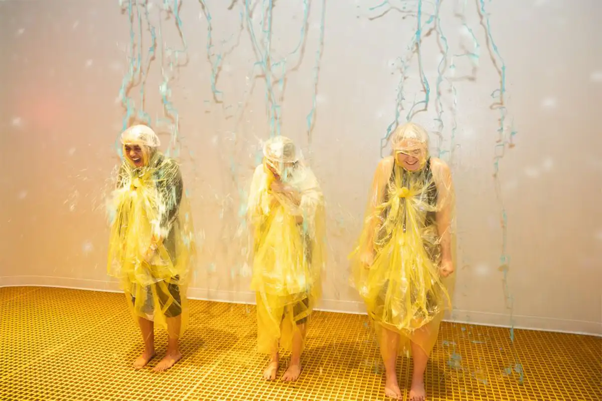 Three kids getting slime poured on them