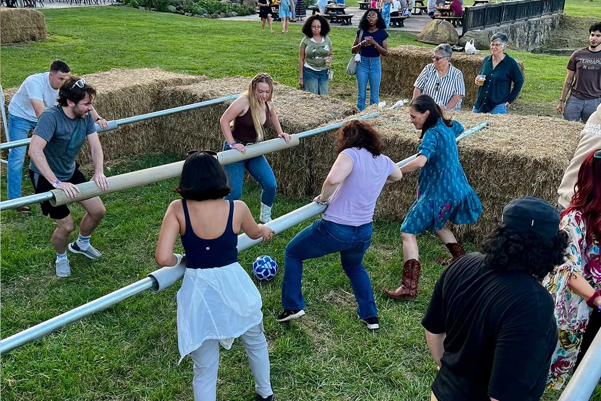 people playing life-size foosball game