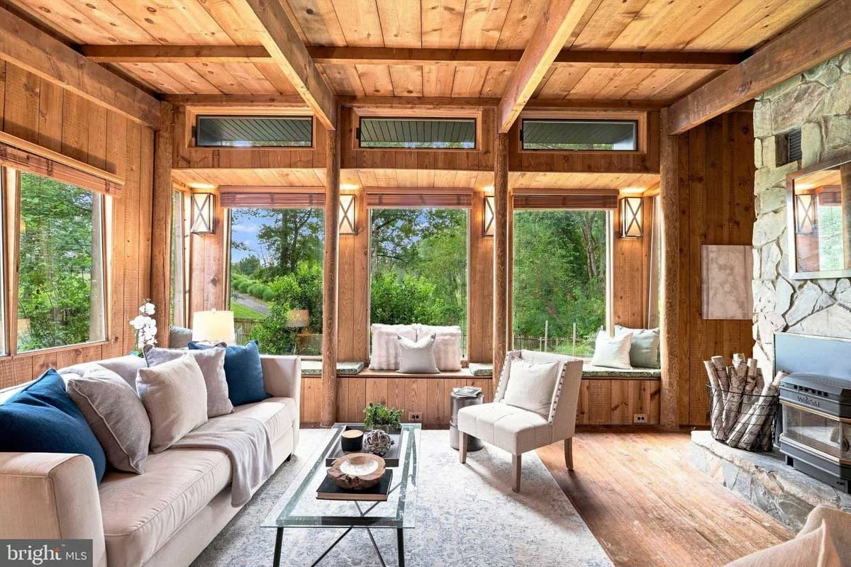 living room with pine wood walls and oversized windows