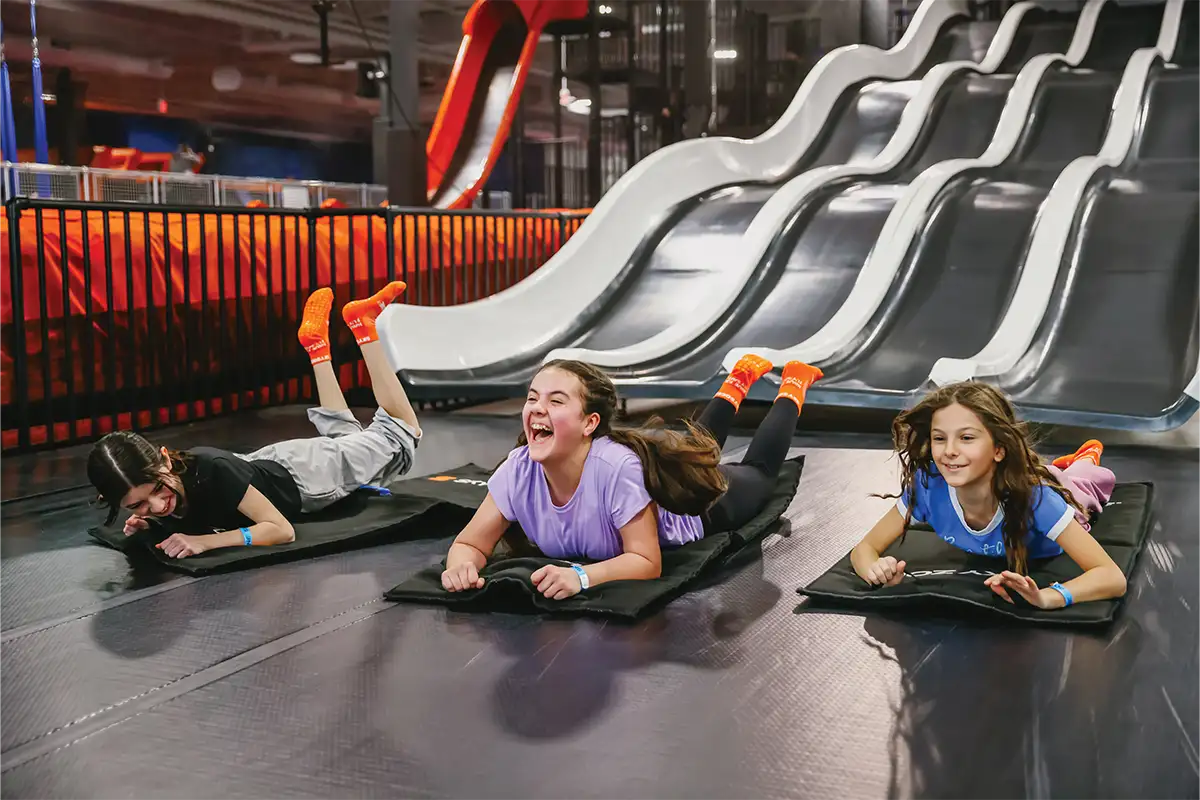 children at the bottom of a slide
