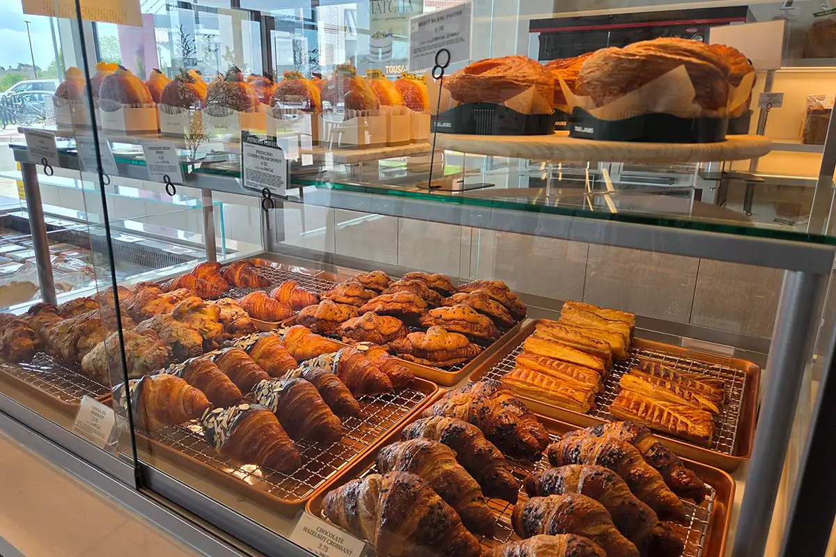 pastries in a glass case at Tous Les Jours