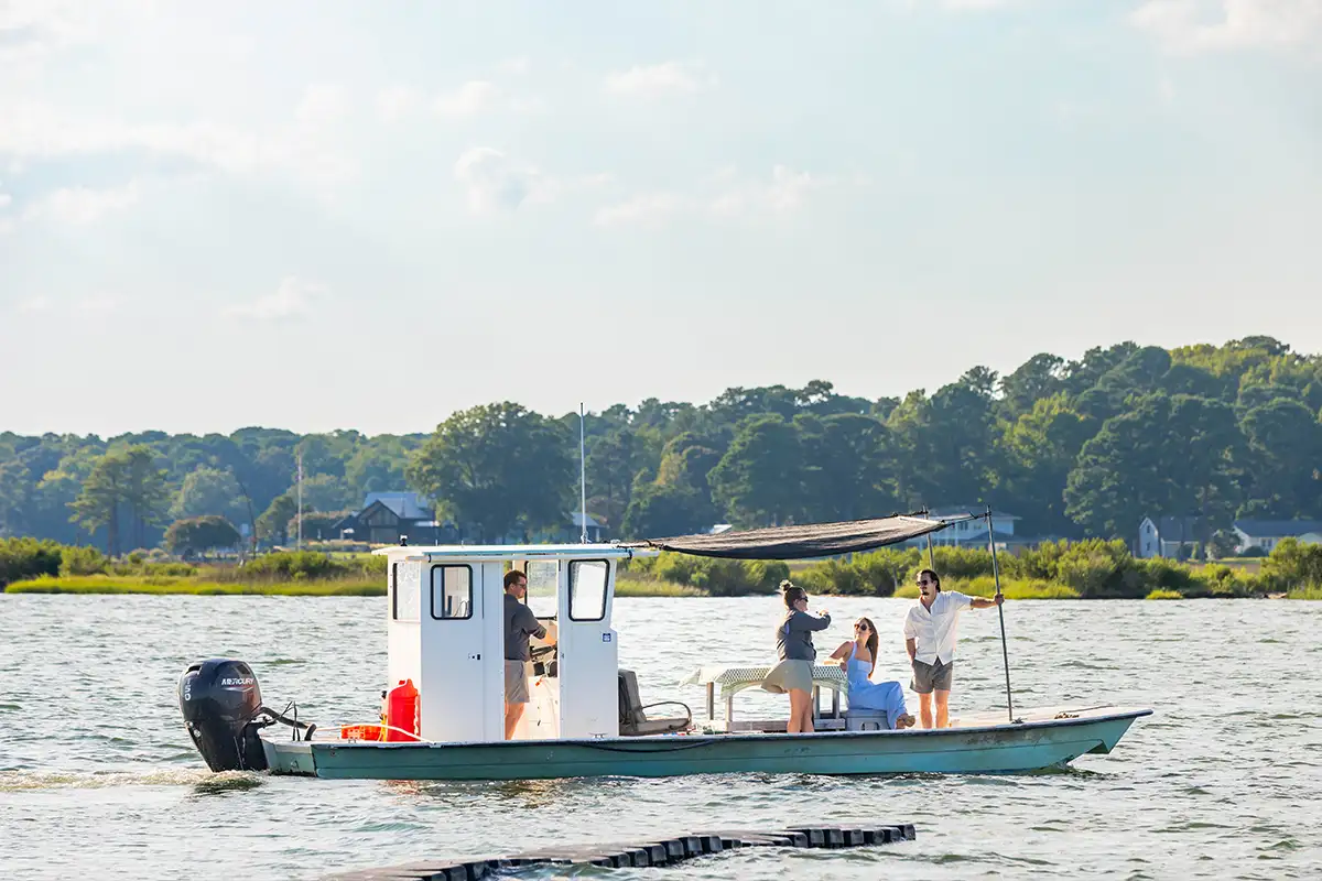 people aboard a Steamboat Wharf Oyster Co fishing boat