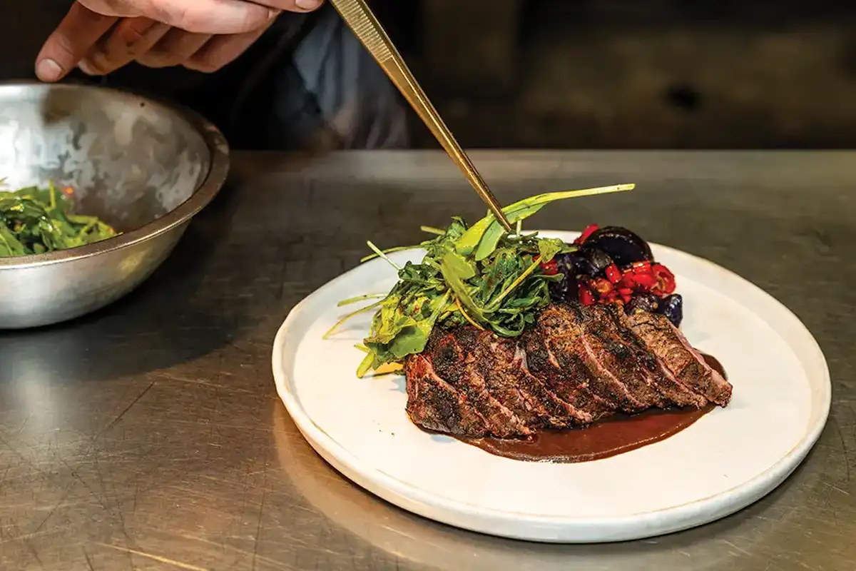 Chef platting dish at Field & Main