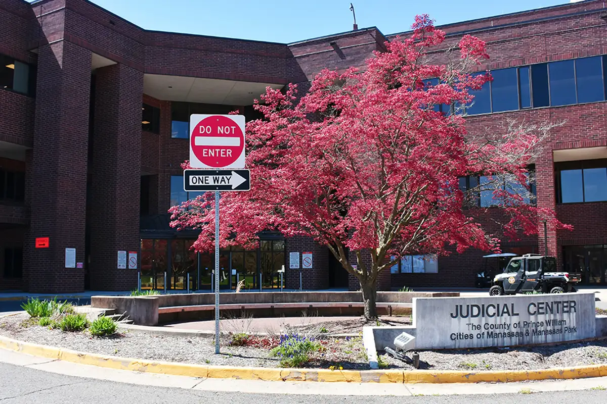 an exterior view of the Prince William County Courthouse with the sign saying Judicial Center, The County of Prince William, Cities of Manassas & Manassas Park