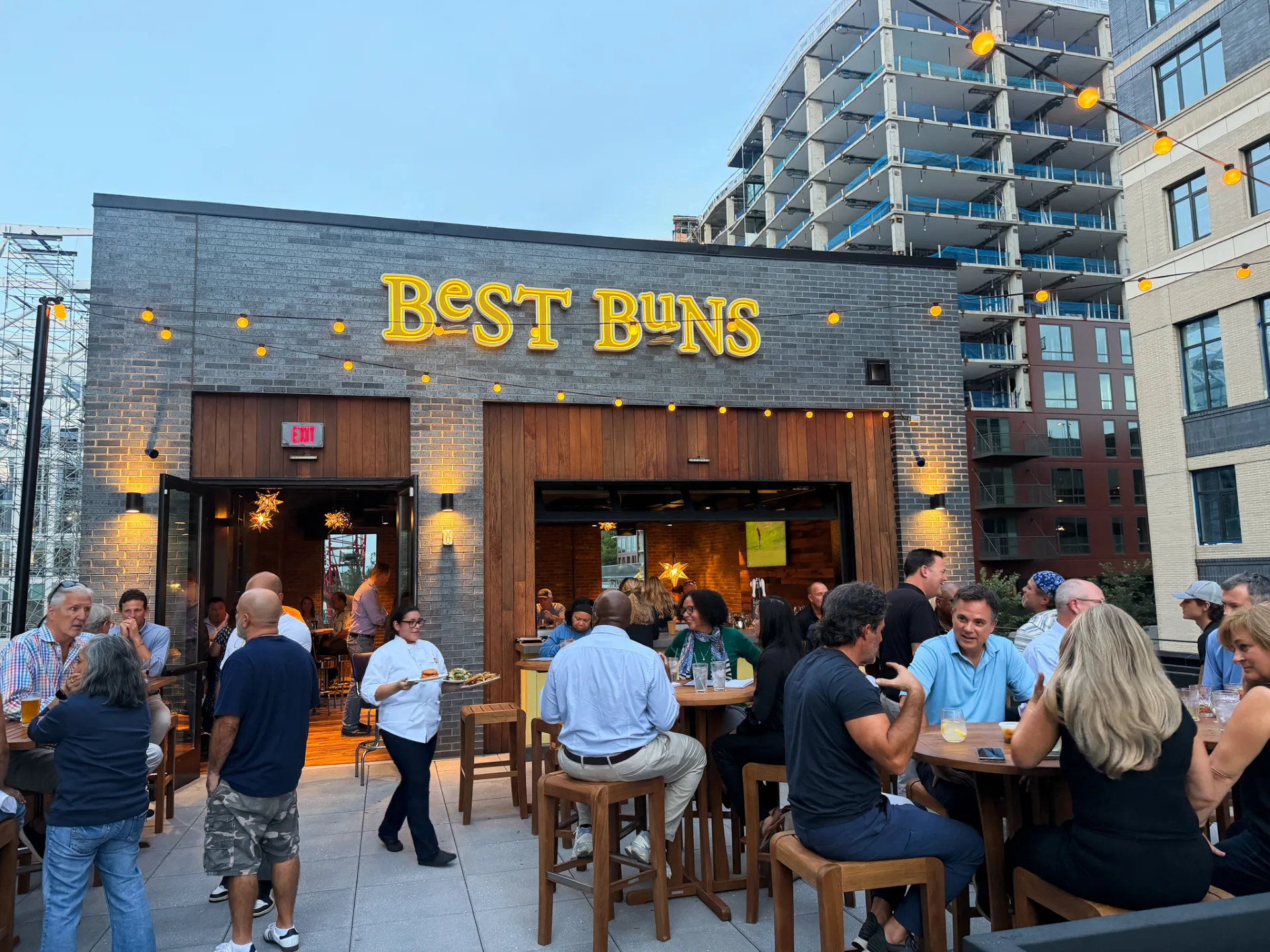 people sit on the outdoor roof top at Best Buns